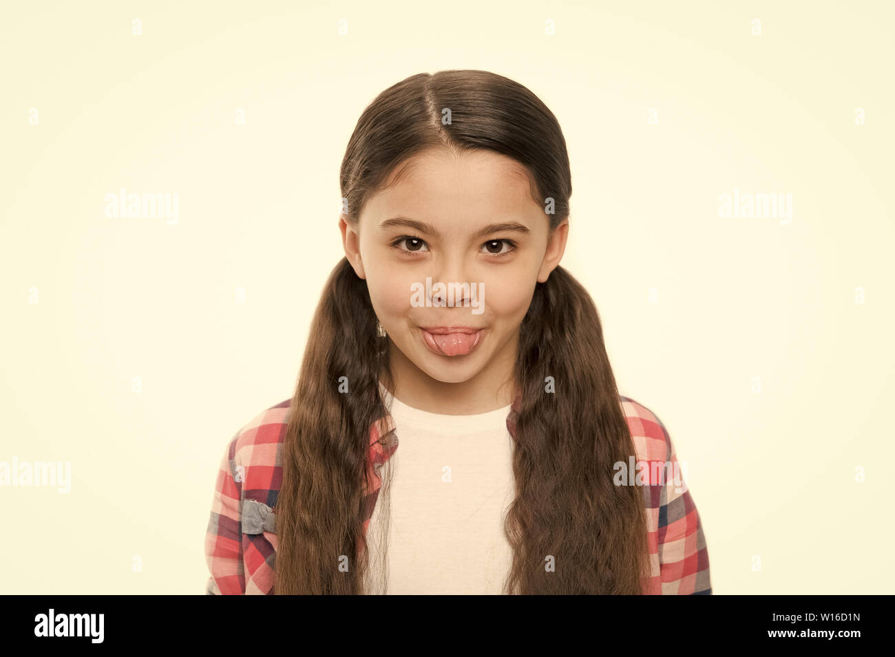 Being A Real Cutie Little Child With Brunette Hair Showing Tongue