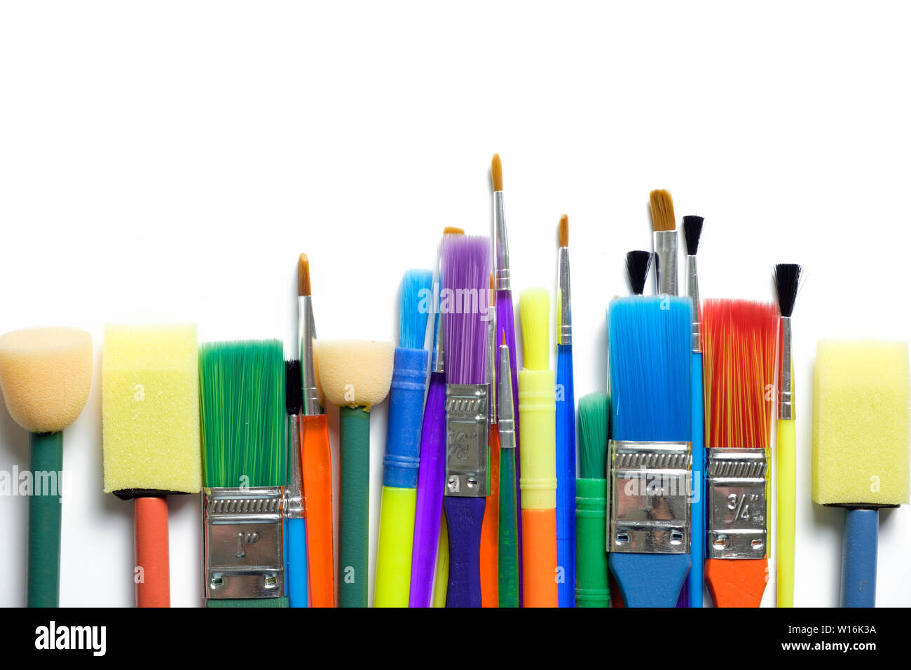 Row of artist paint brushes on white background Stock Photo