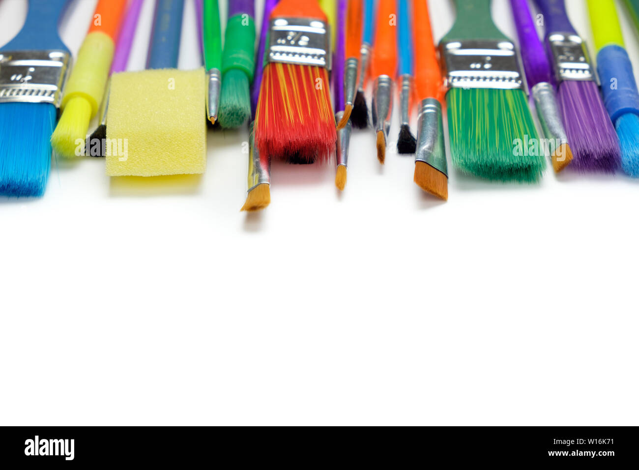 Row of artist paint brushes on white background Stock Photo