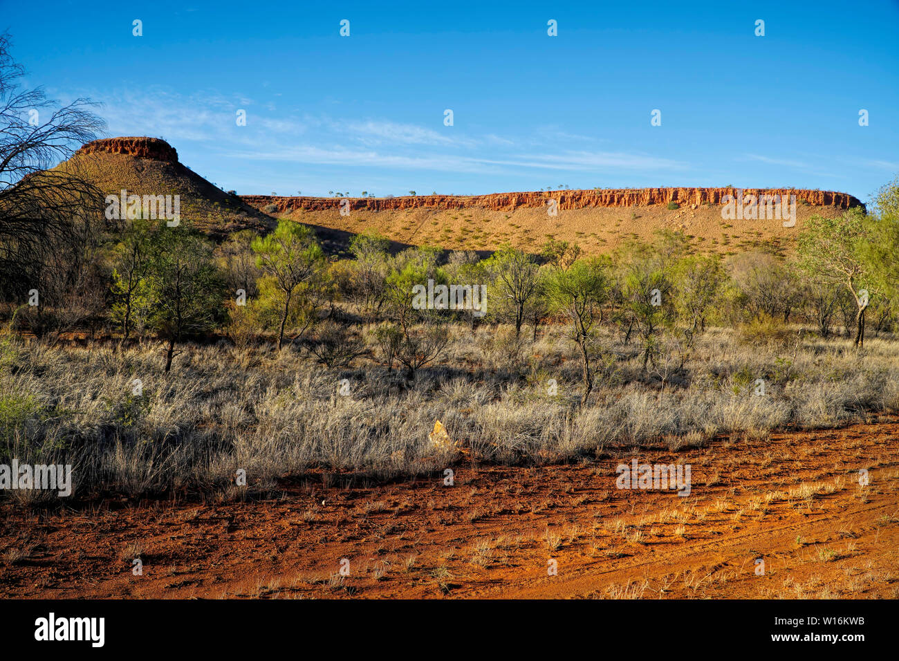 Road into Alice Springs near Barrow Creek view of mountain range Stock Photo