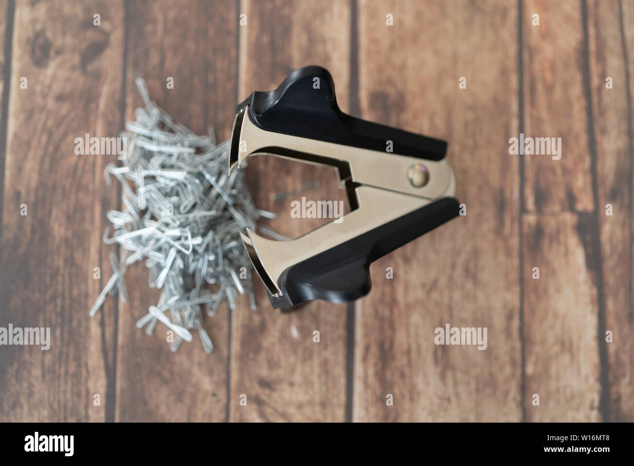 Staple pin remover with pile of staple pins Stock Photo Alamy