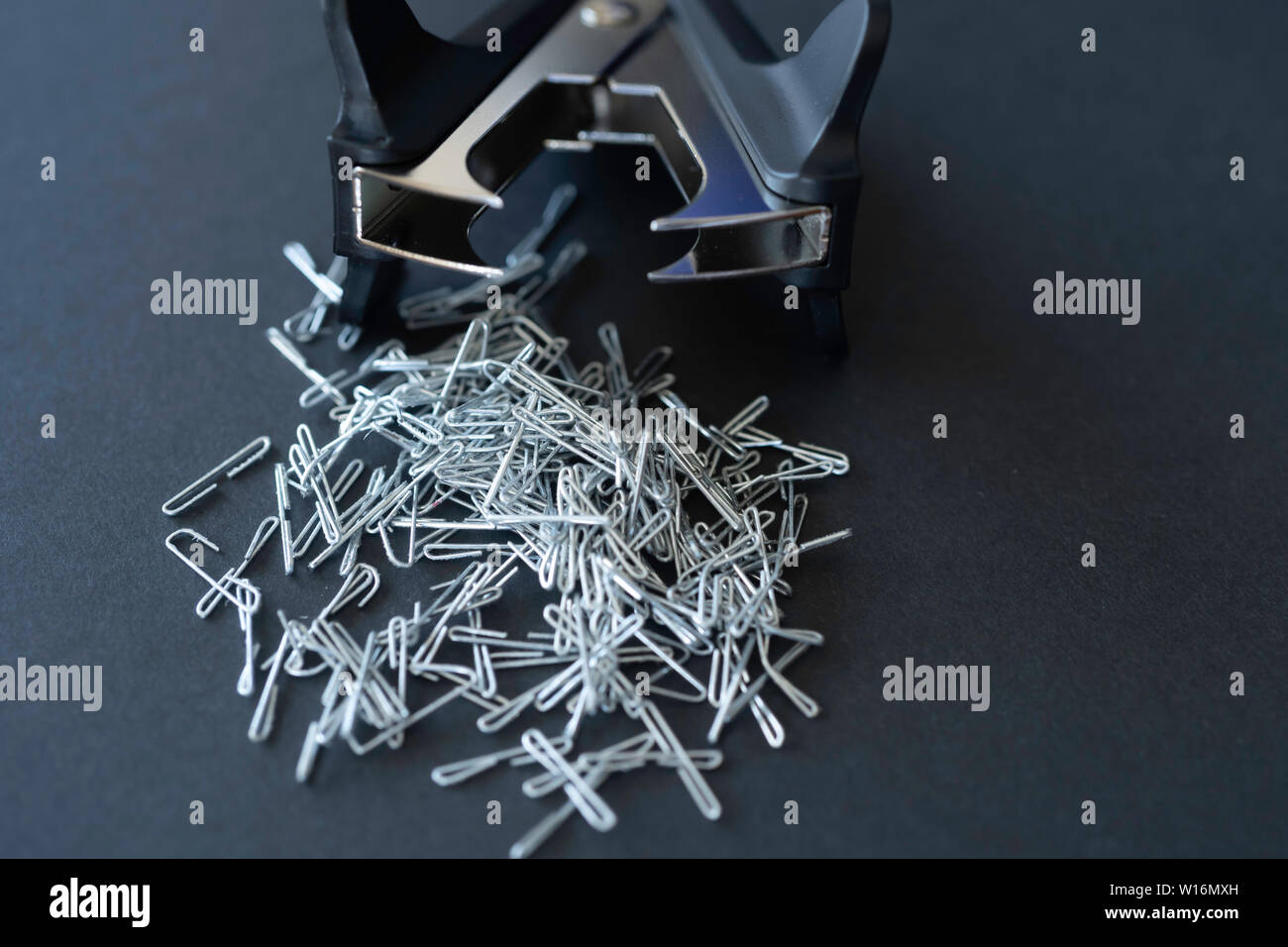 Staple pin remover with pile of staple pins Stock Photo Alamy