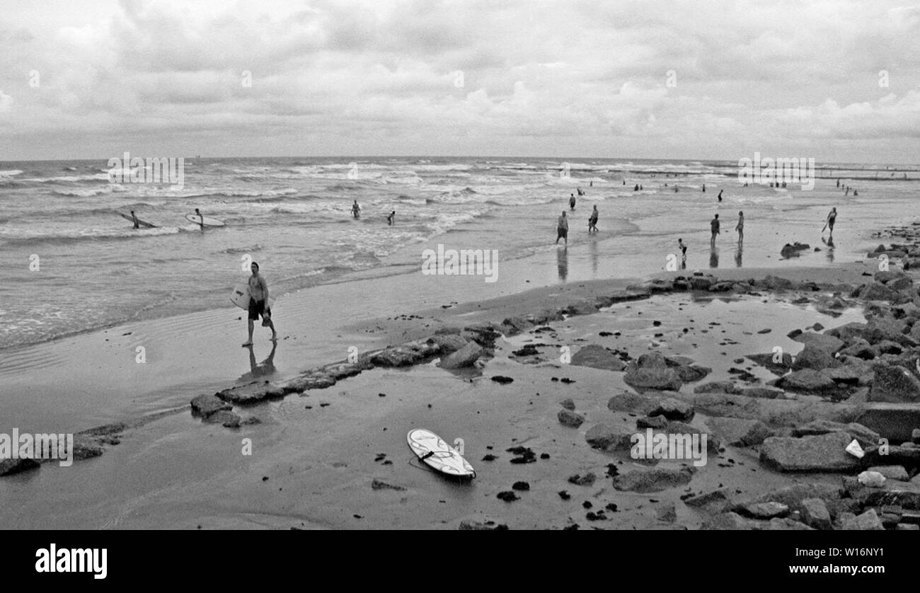 Storm is coming and the waves get bigger, a great time to surf along the Gulf of Mexico. Taken along the beaches in Galveston, Texas in early September.   Never got to be a hurricaine, just another tropical storm. Stock Photo