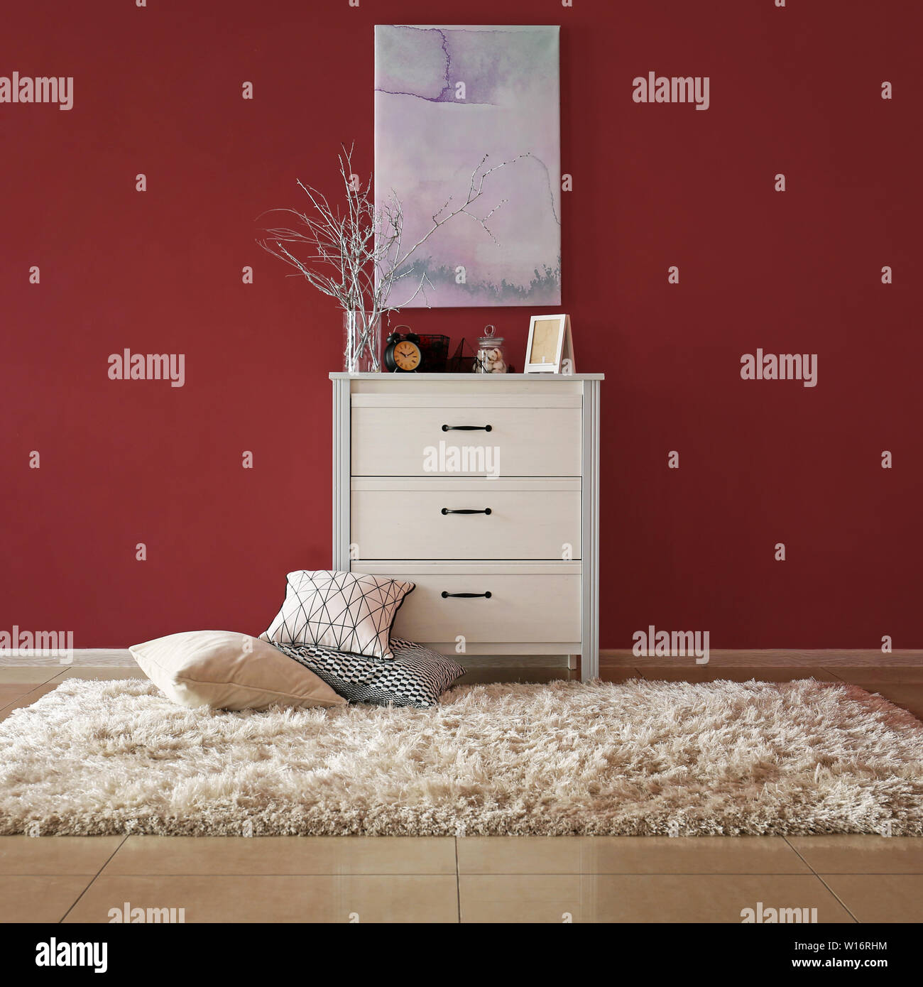 Chest Of Drawers With Stylish Decor And Pillows Near Color Wall In