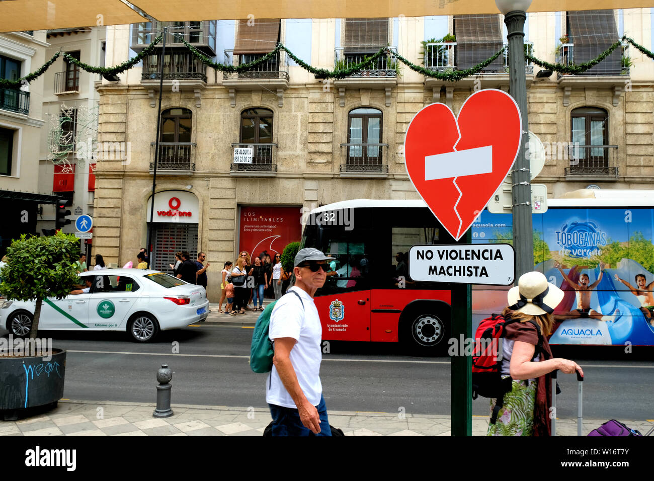 Sign in the shape of a broken heart pleading for the end to gender violence in downtown Granada, Spain; 'no violencia machista' (no macho violence). Stock Photo