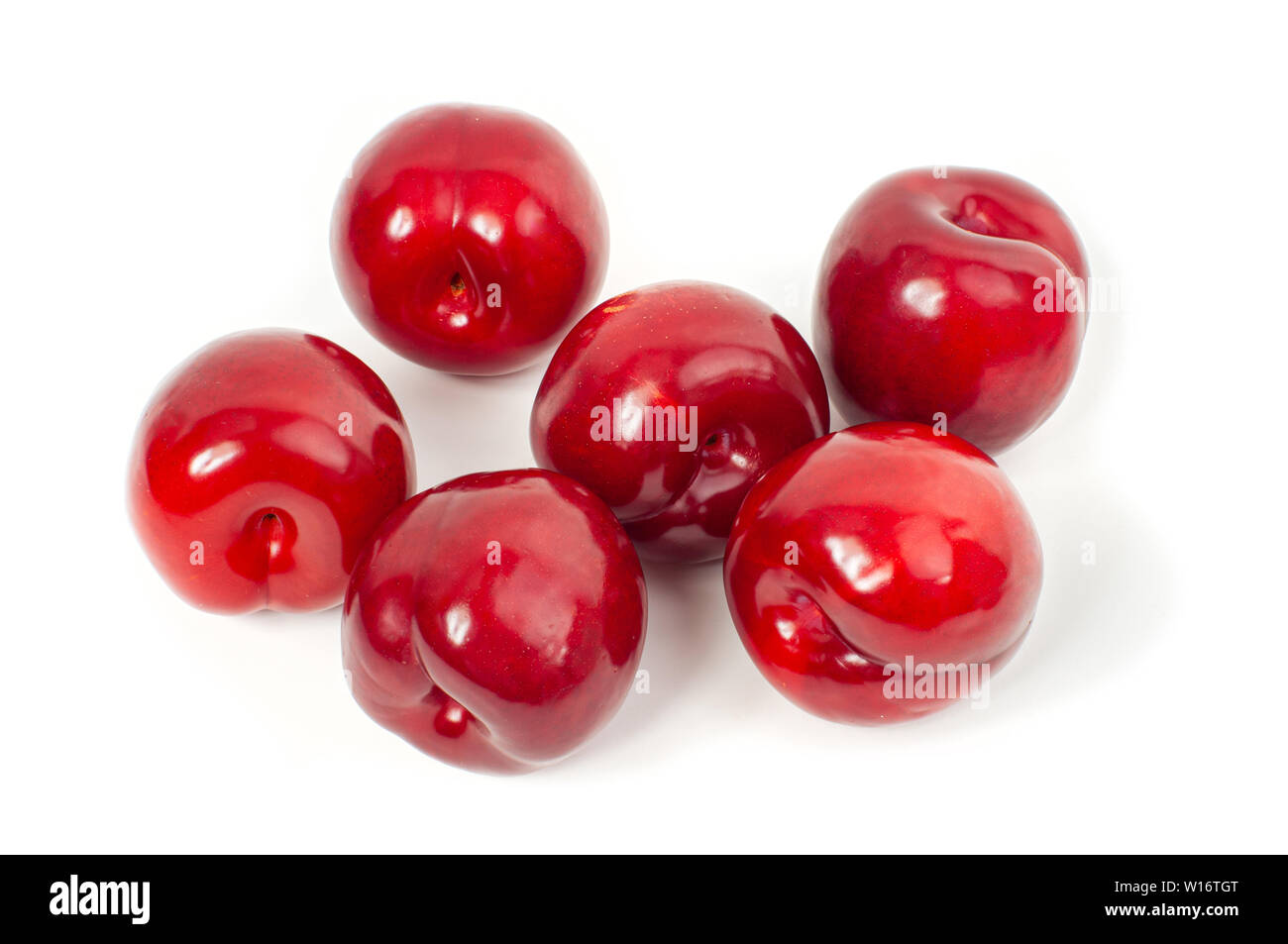 Fresh red plums on white background. Dieting Stock Photo