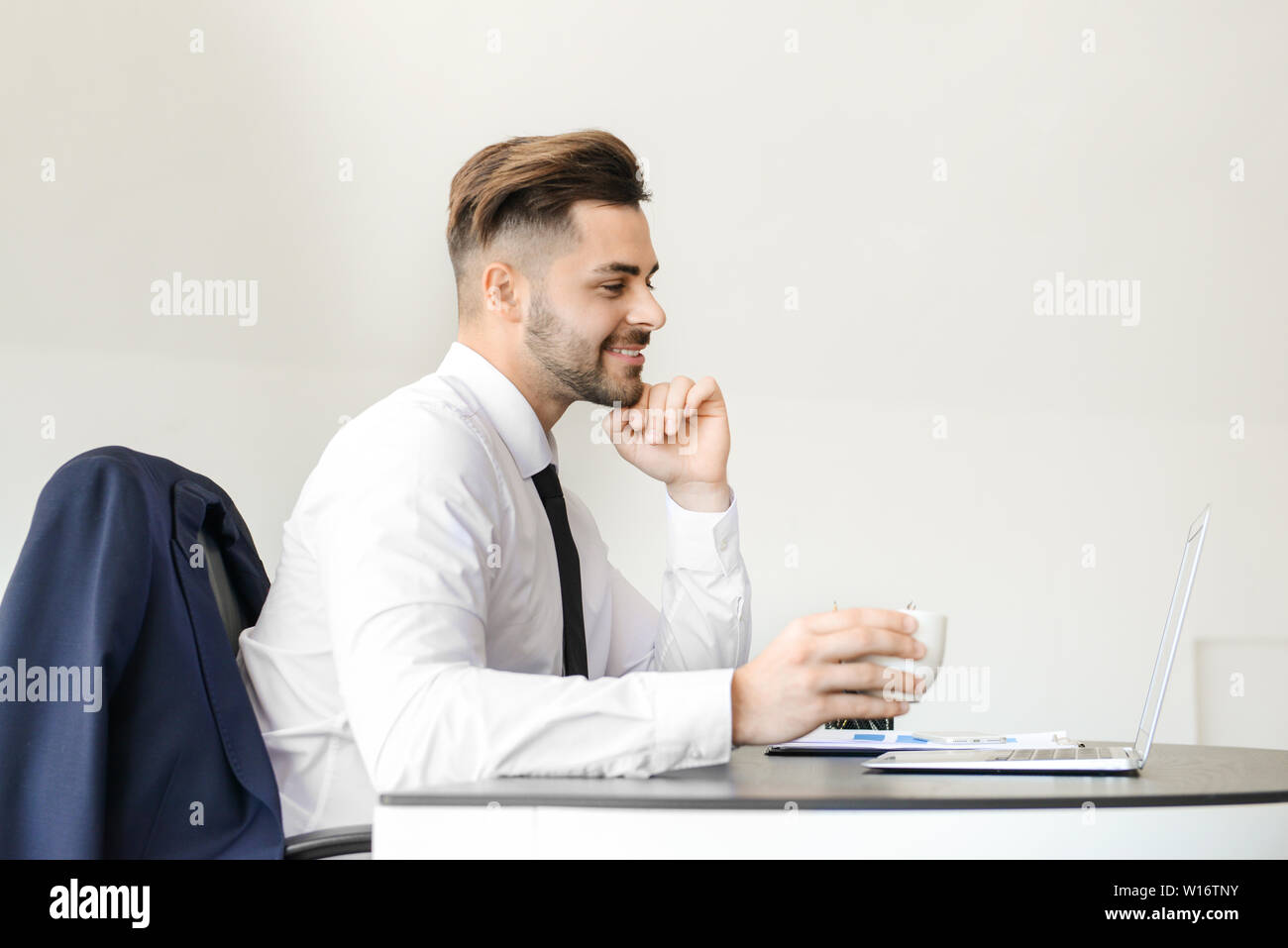 Handsome businessman having break during work in office Stock Photo