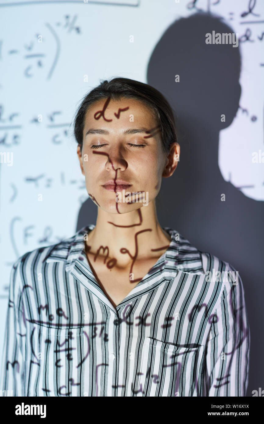 Mathmatition Lady Serious calm young lady mathematician in stripped shirt standing in ...
