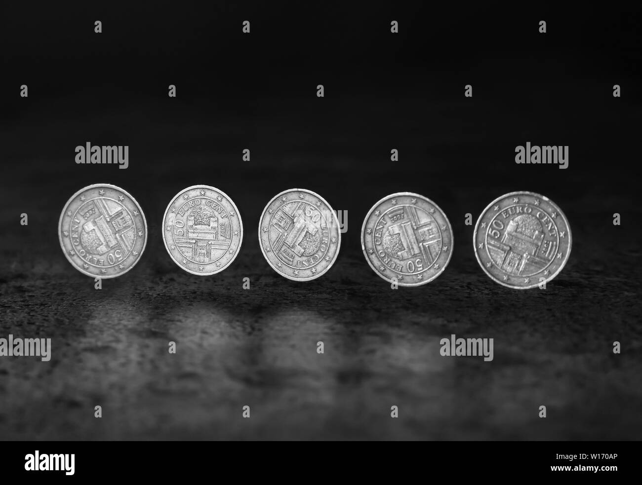 Stroboscopic photo of rolling coin on dark background Stock Photo