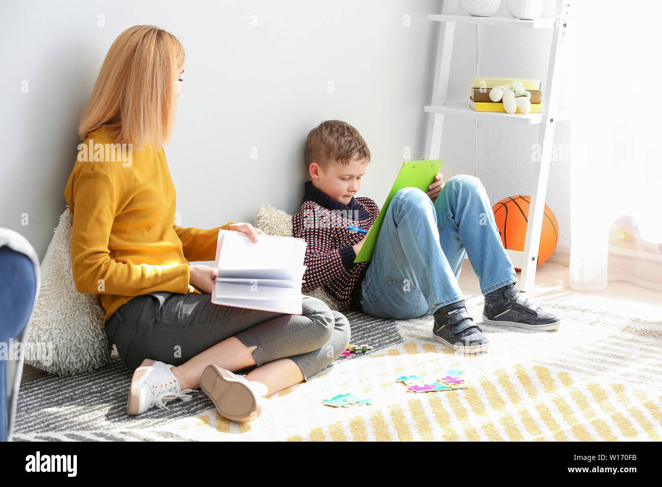 Female psychologist working with boy suffering from autistic disorder Stock Photo Alamy