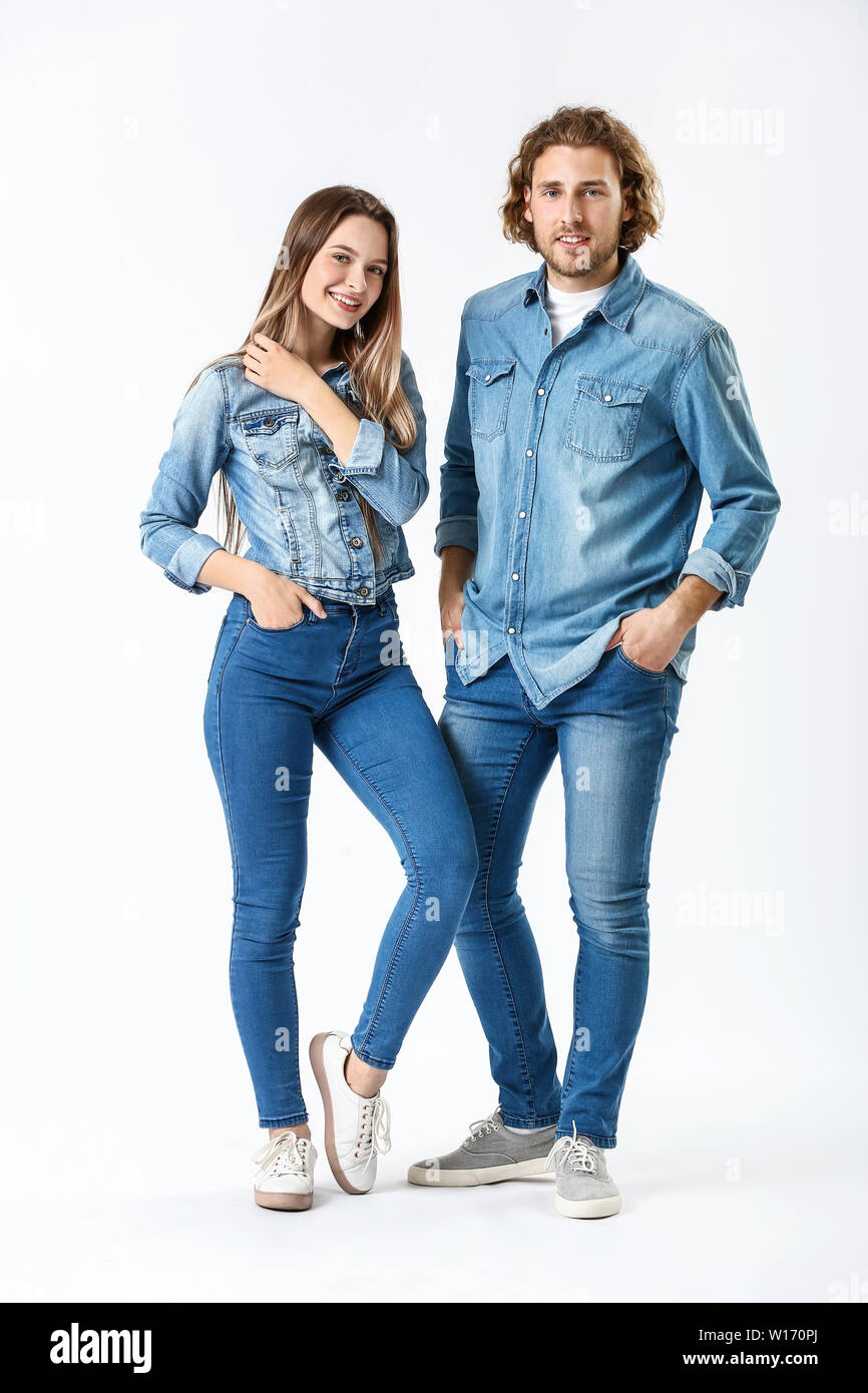 Stylish young couple in jeans clothes on white background Stock Photo -  Alamy
