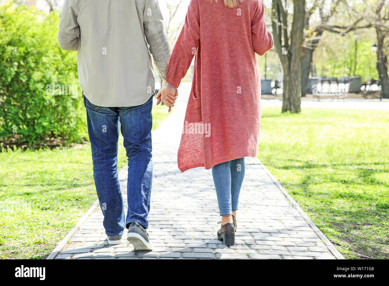 Happy elderly couple walking in park Stock Photo