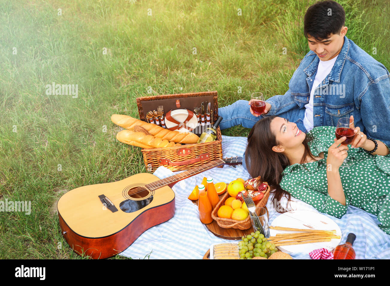 Happy young couple on picnic in park Stock Photo - Alamy