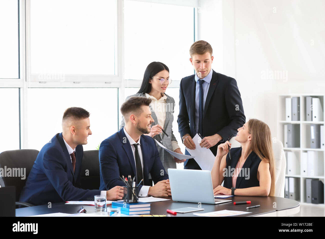 Team of business people during meeting in office Stock Photo - Alamy