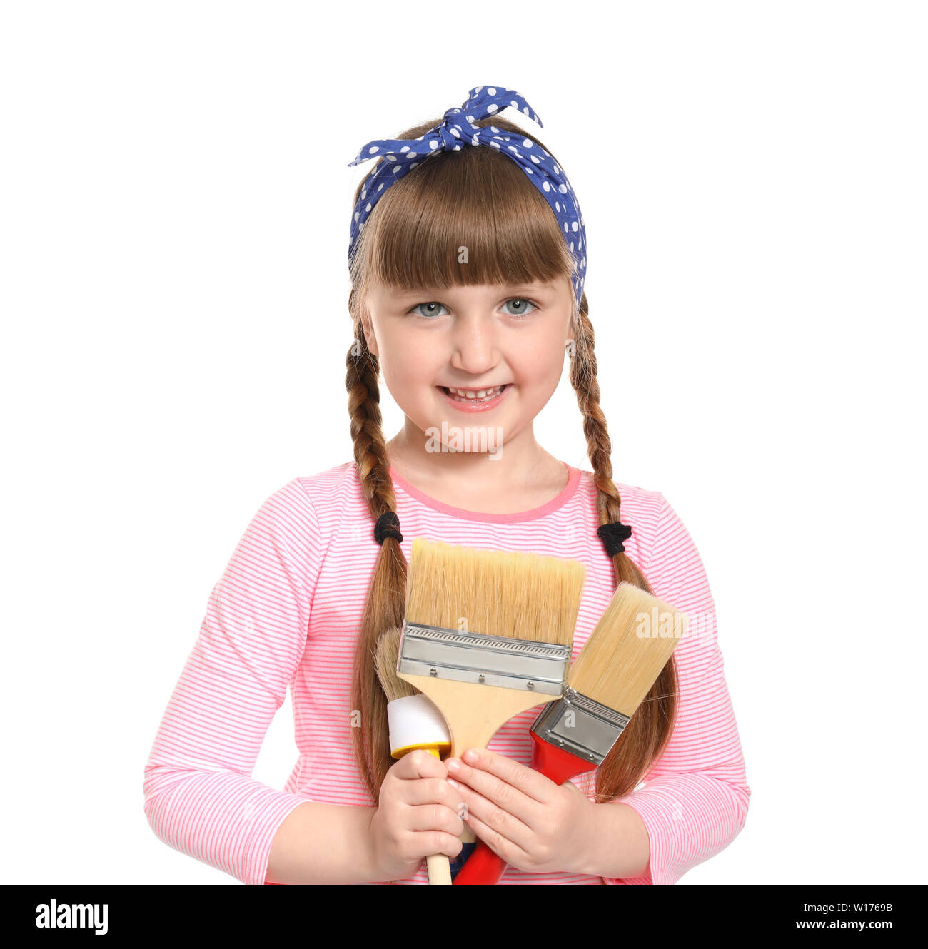 Cute little girl with brushes on white background Stock Photo - Alamy