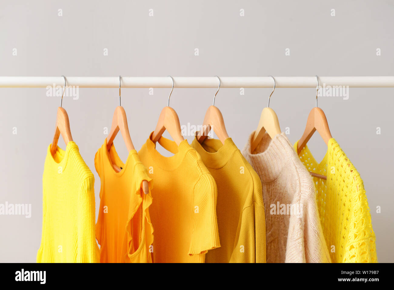 Concept of dry cleaning service. Hangers with clean clothes hanging on rack  Stock Photo - Alamy