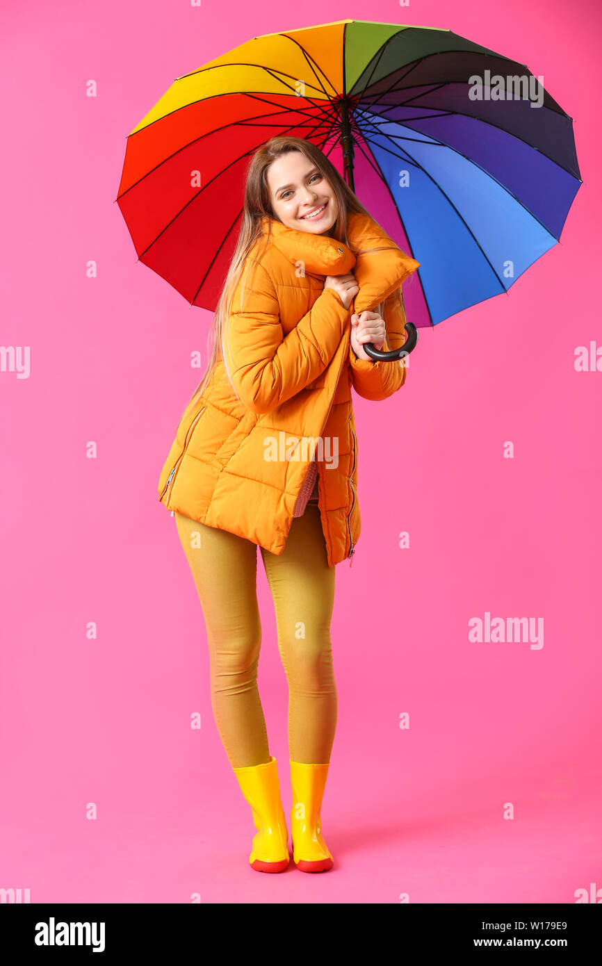 Beautiful young woman with umbrella on color background Stock Photo - Alamy