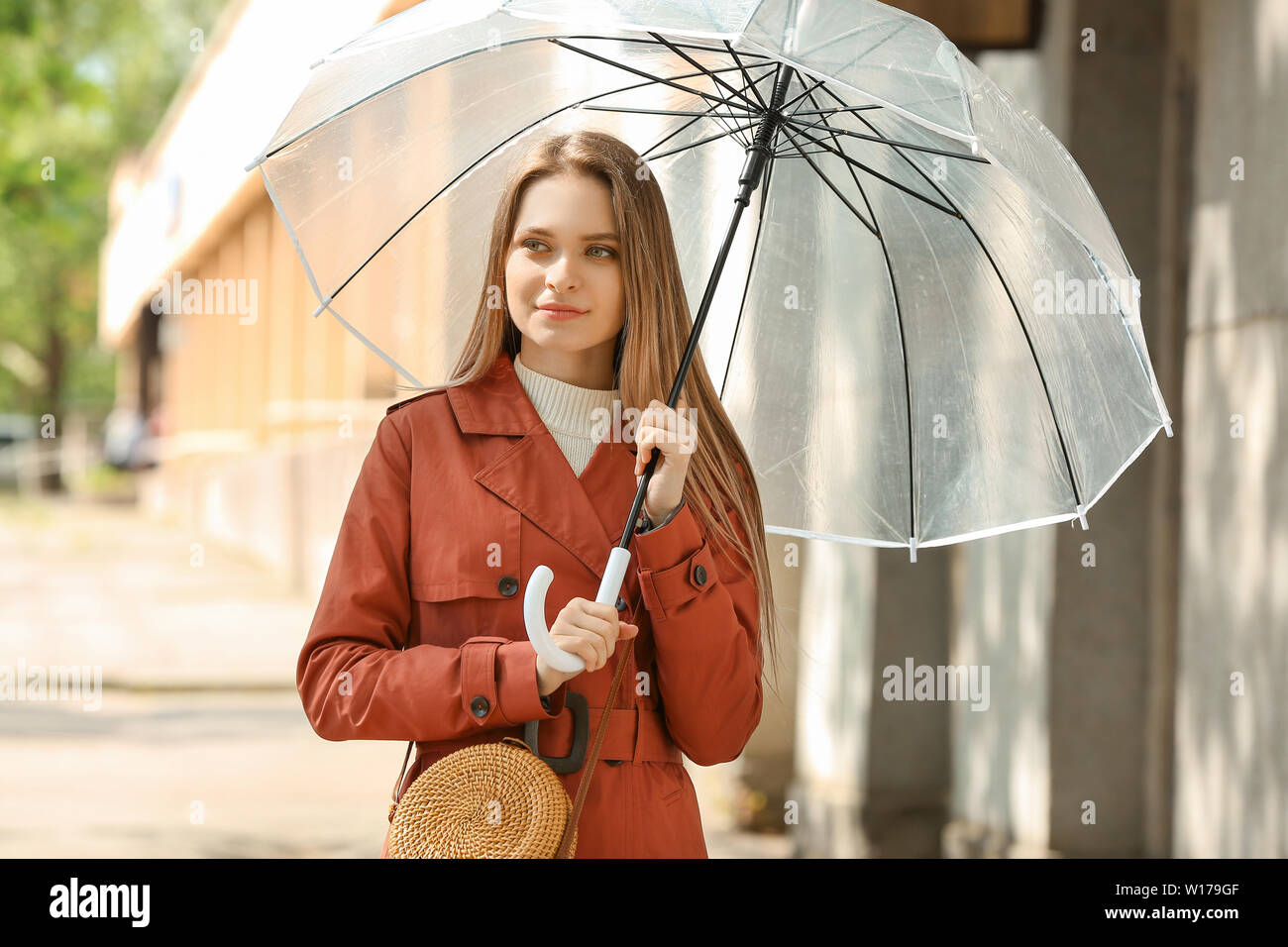 Beautiful young woman with umbrella outdoors Stock Photo - Alamy