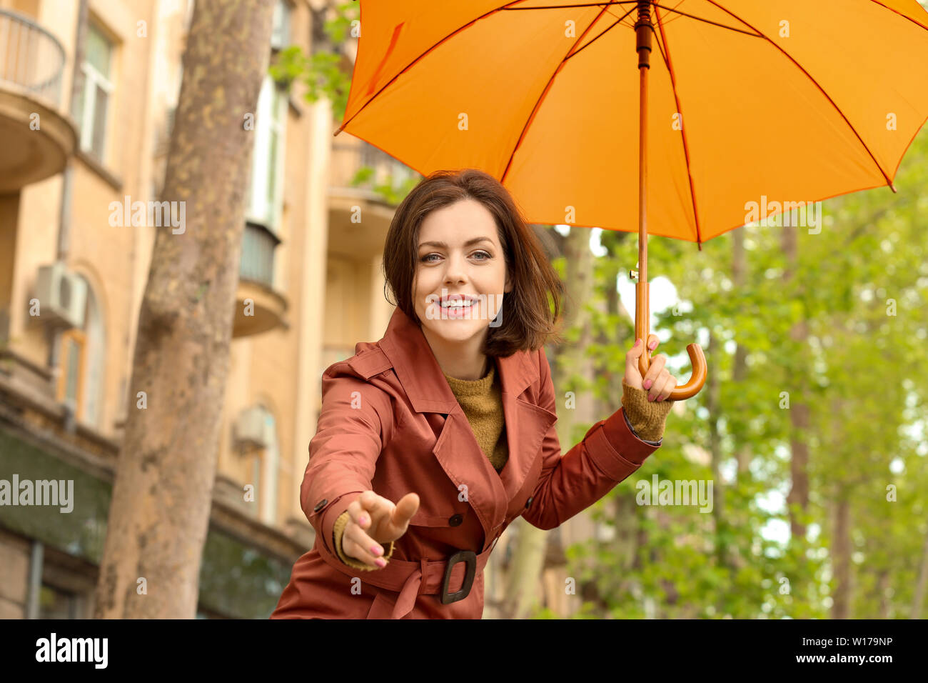 Beautiful young woman with umbrella outdoors on rainy day Stock Photo ...