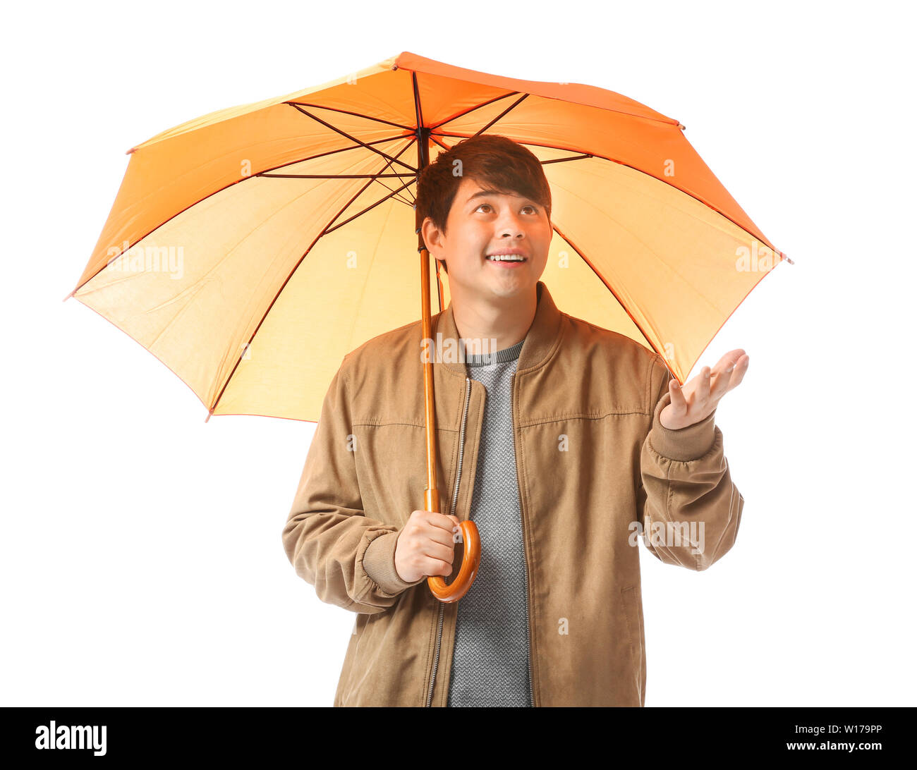 Handsome Asian man with umbrella on white background Stock Photo - Alamy