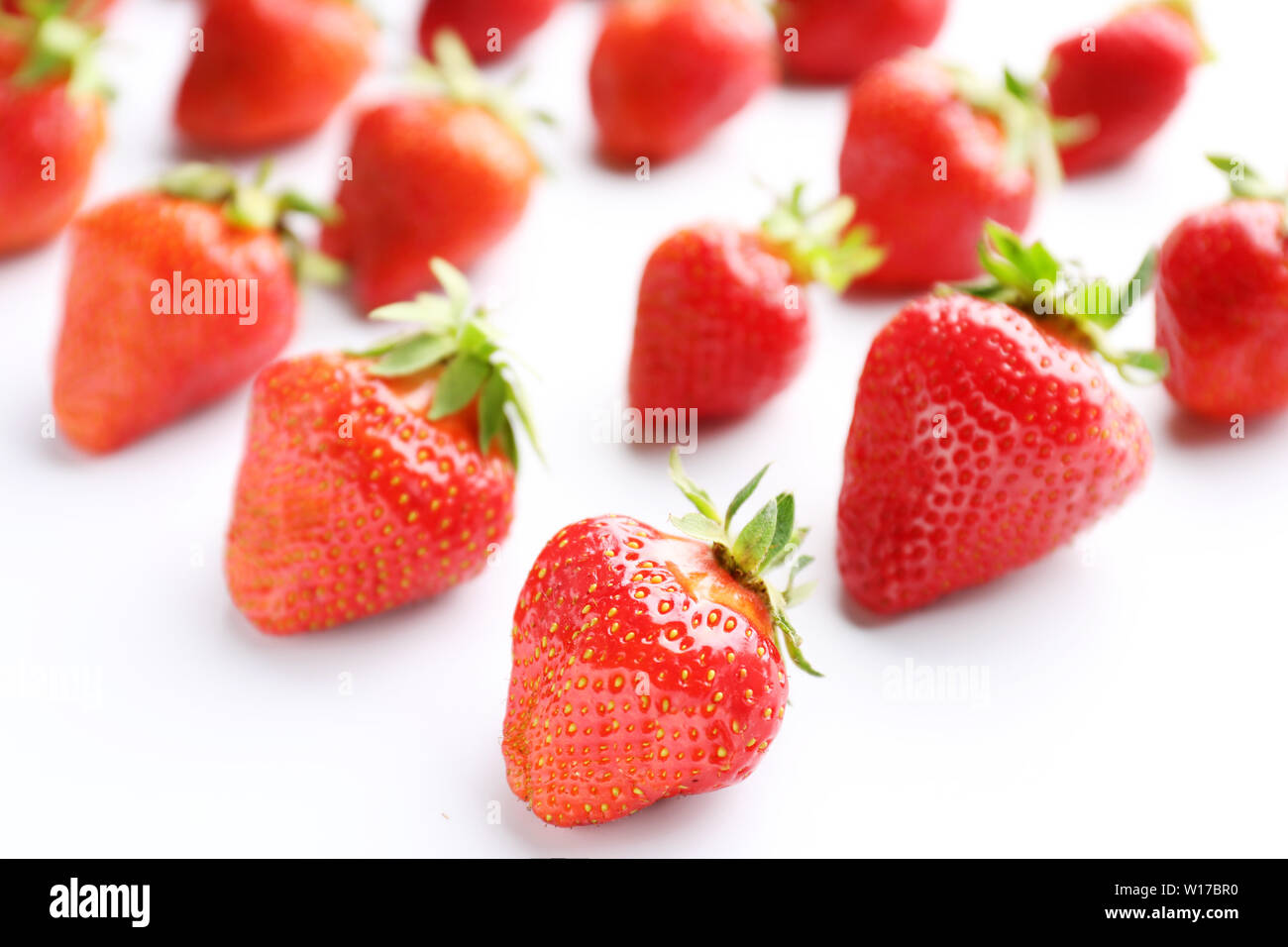 Ripe red strawberry on white background Stock Photo - Alamy