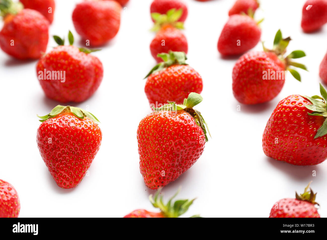 Ripe red strawberry on white background Stock Photo - Alamy