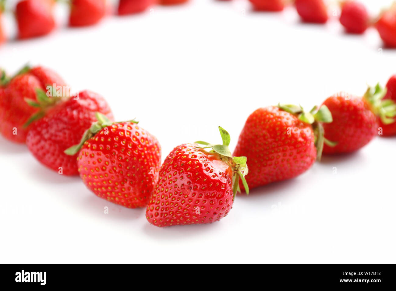 Ripe red strawberry on white background Stock Photo - Alamy