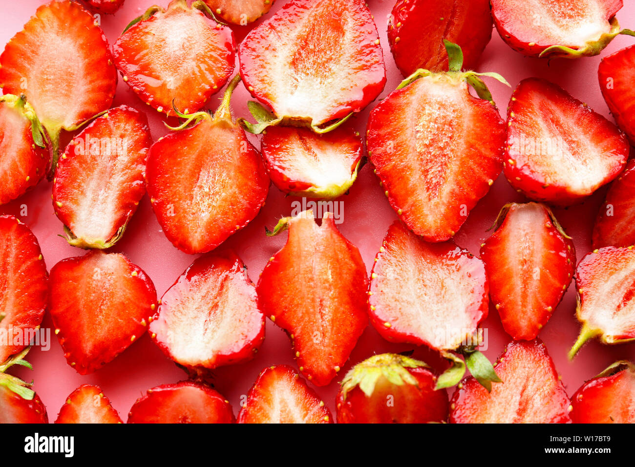 Ripe cut red strawberry as background Stock Photo - Alamy