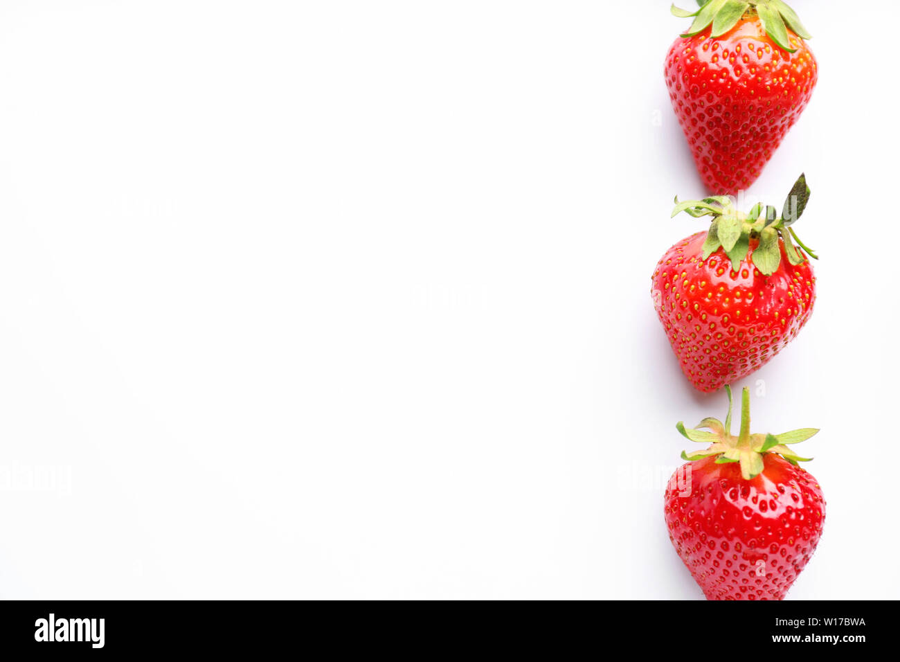 Ripe red strawberry on white background Stock Photo - Alamy