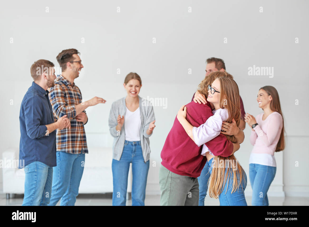 Young woman calming man at group therapy session Stock Photo