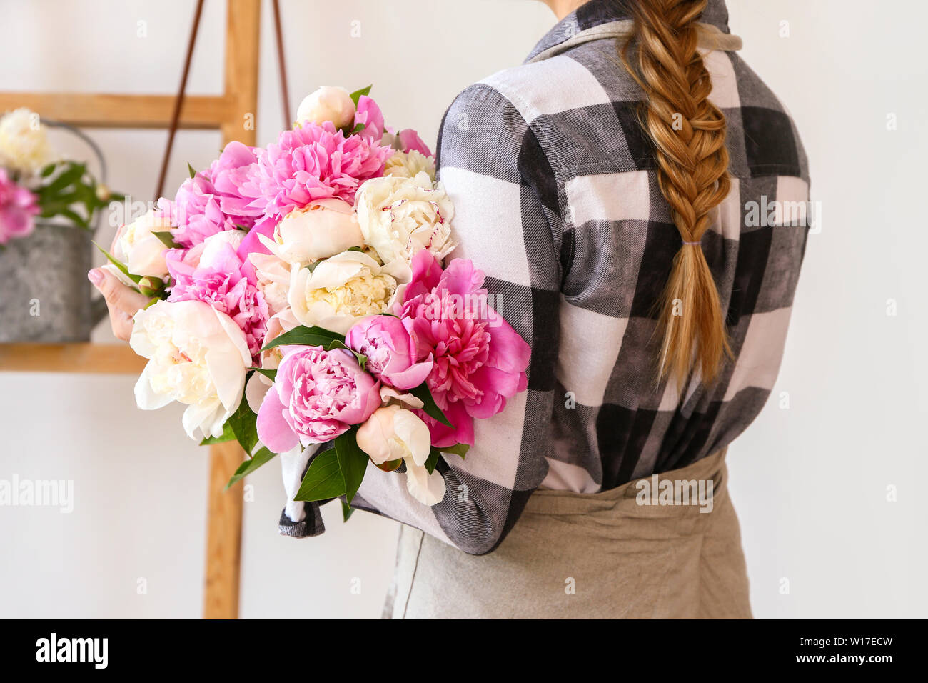 Female florist with beautiful bouquet of peonies in shop Stock Photo ...