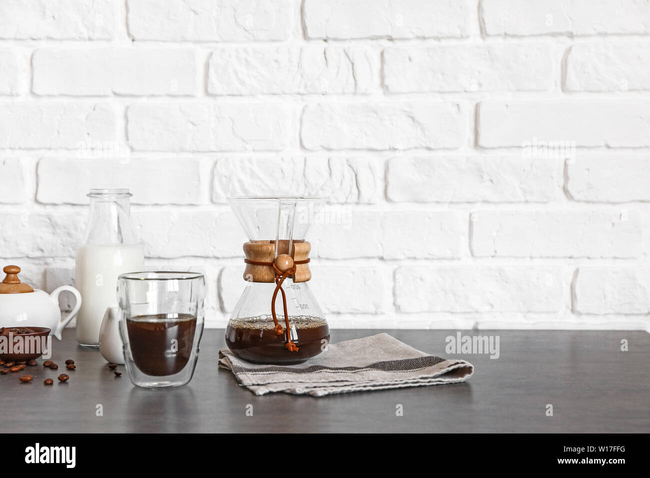 Glass And Chemex Of Hot Coffee On Table Near Brick Wall Stock Photo Alamy