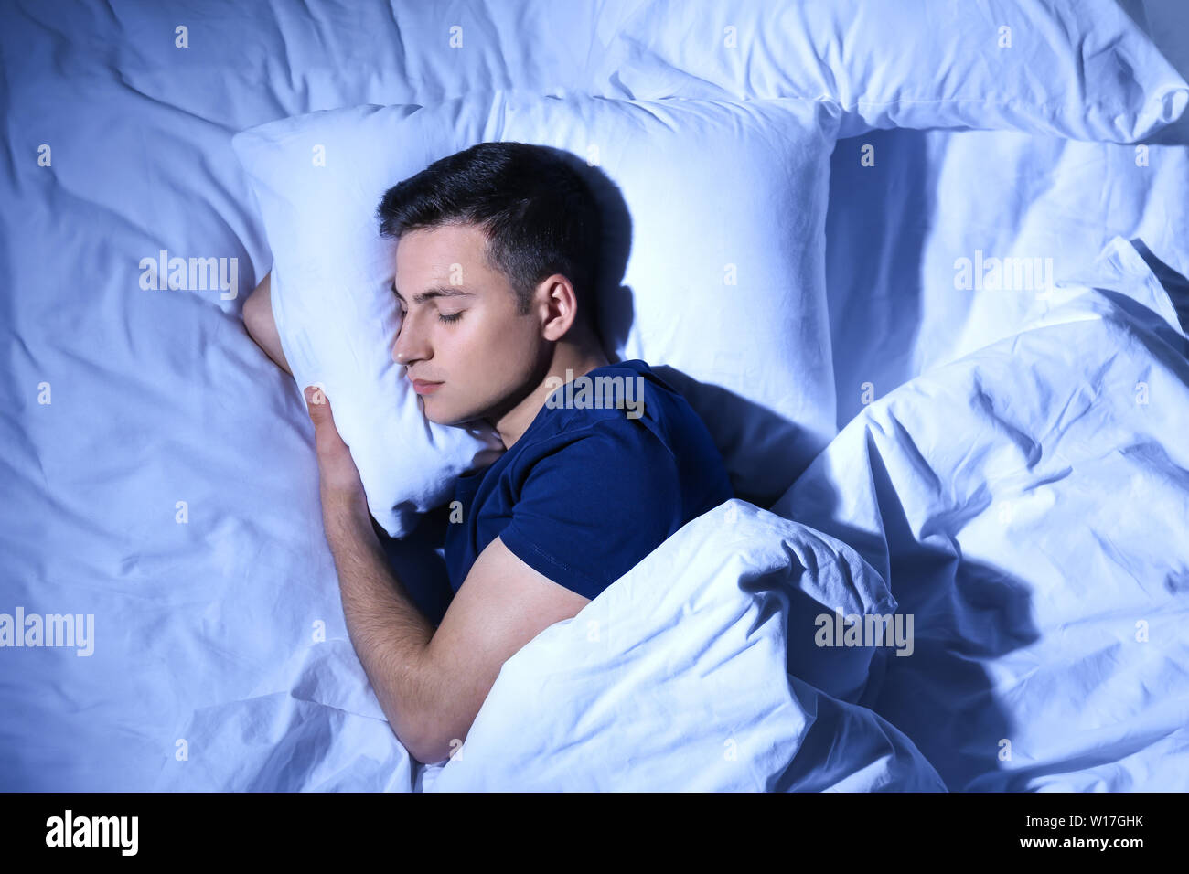Man sleeping in bed at night hi-res stock photography and images - Alamy