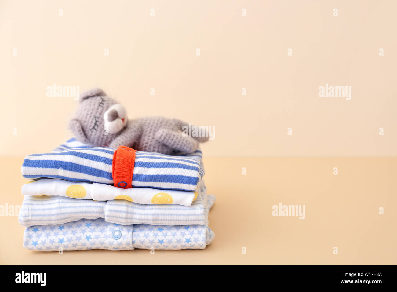 Stack of baby clothes on color background Stock Photo - Alamy