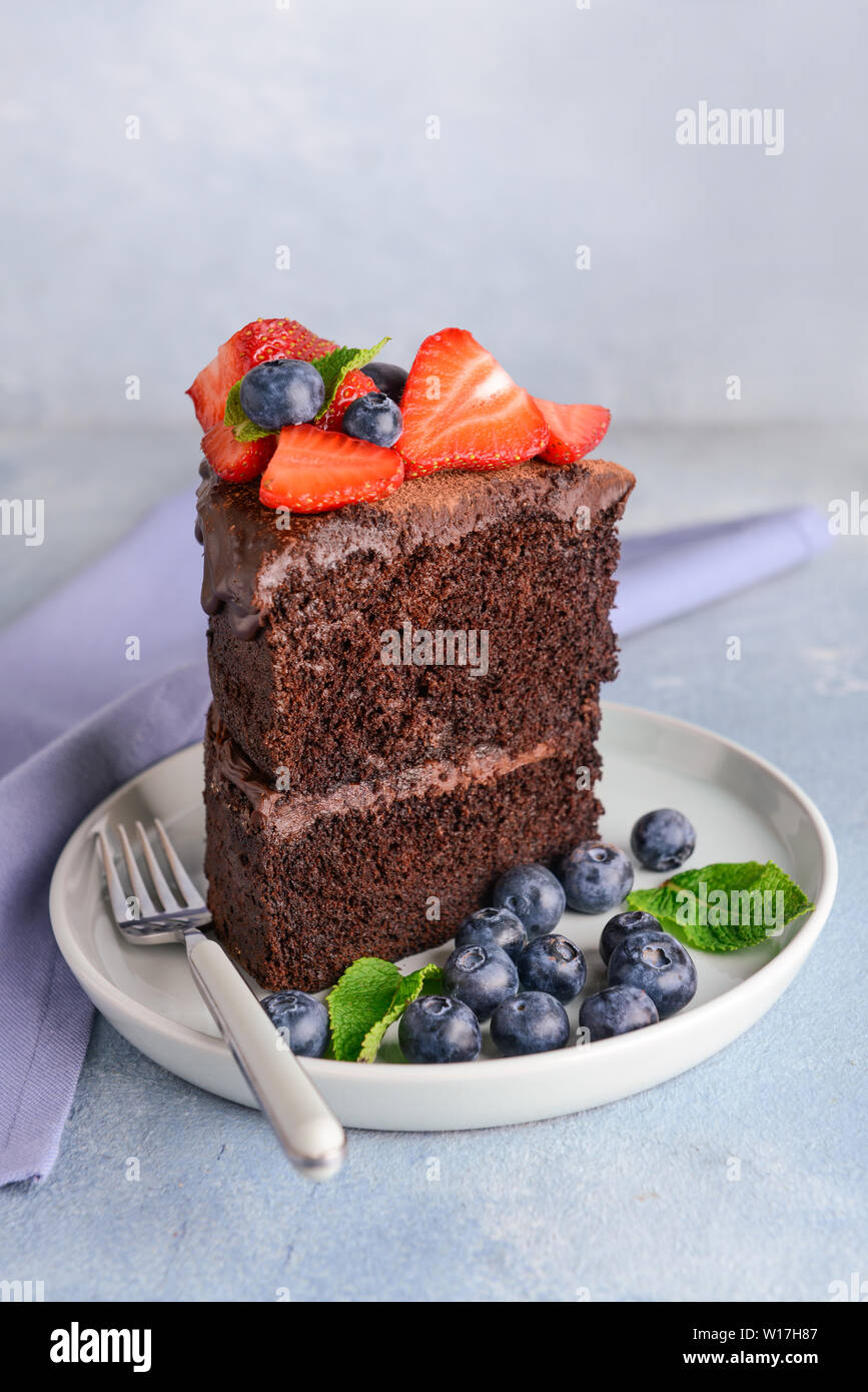 Plate with piece of tasty chocolate cake on table Stock Photo - Alamy