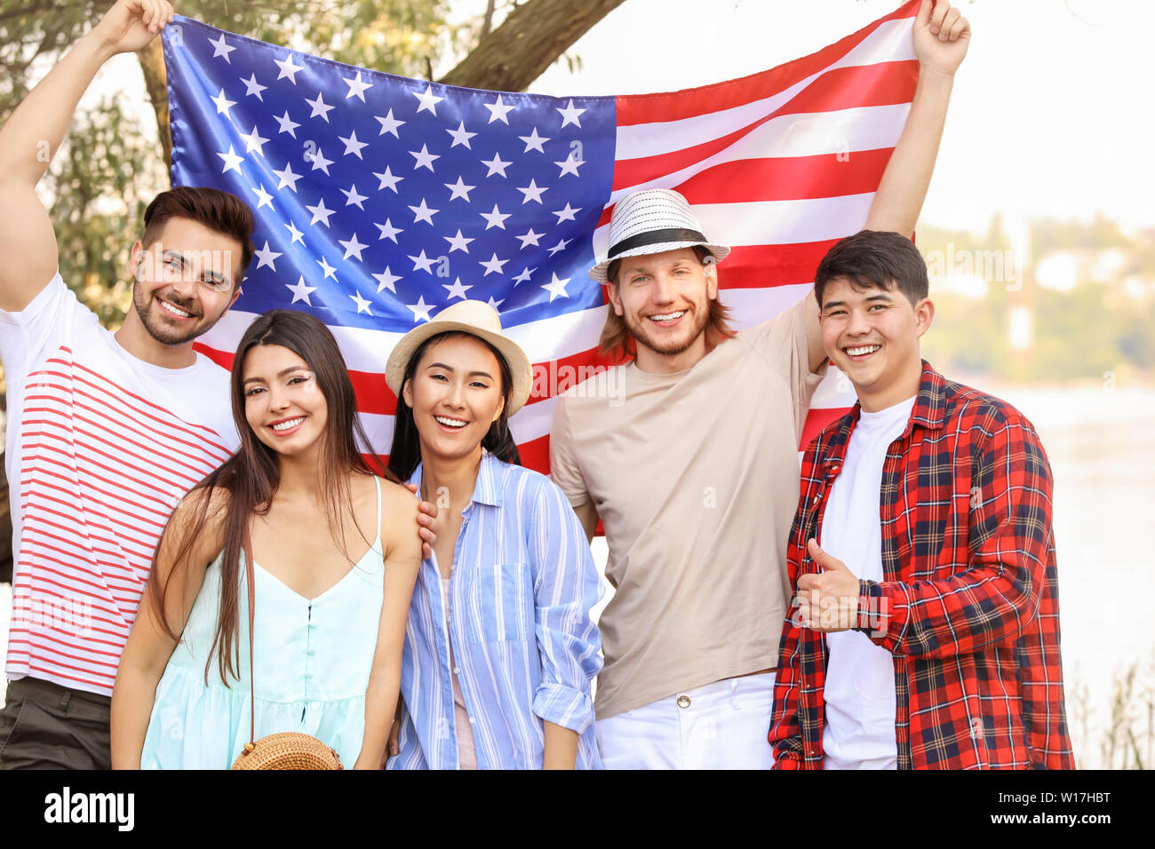 Young people with USA flag outdoors. Independence Day celebration Stock  Photo - Alamy, image size:1300x956