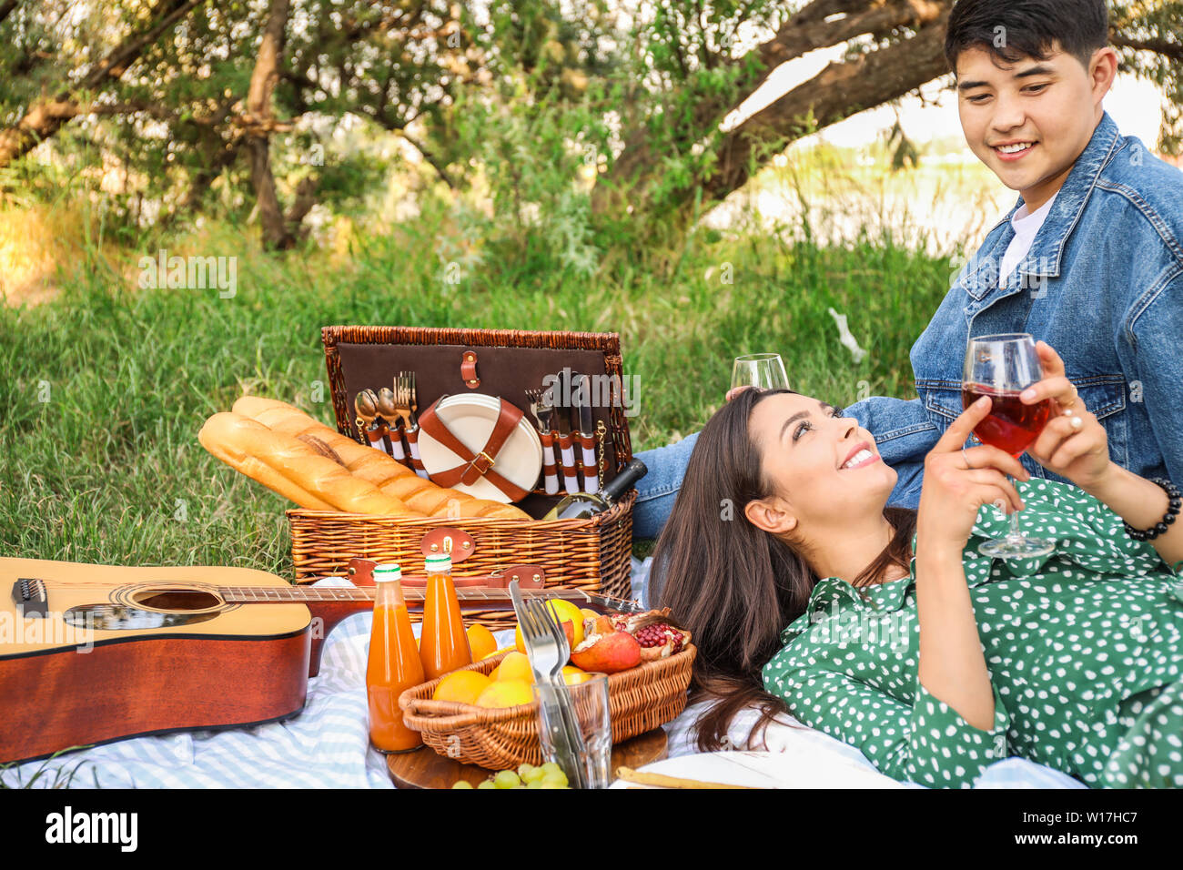 Happy young couple on picnic in park Stock Photo - Alamy