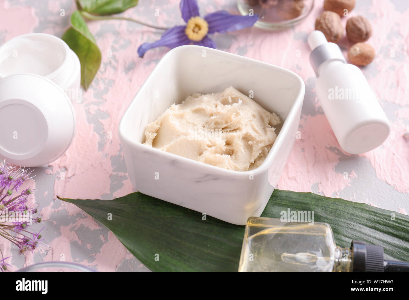 Shea butter with cosmetic products on color background Stock Photo Alamy