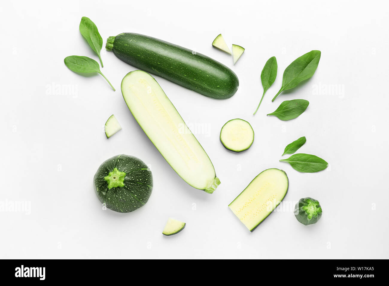 Cut zucchini squashes on white background Stock Photo