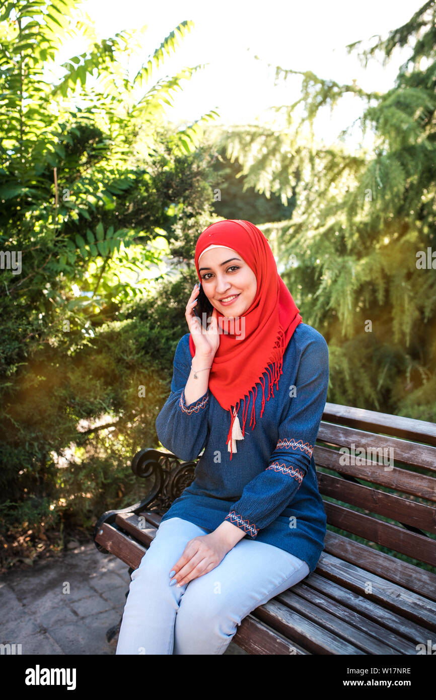 Beautiful young arabic girl in hijab posing for a camera at summer ...