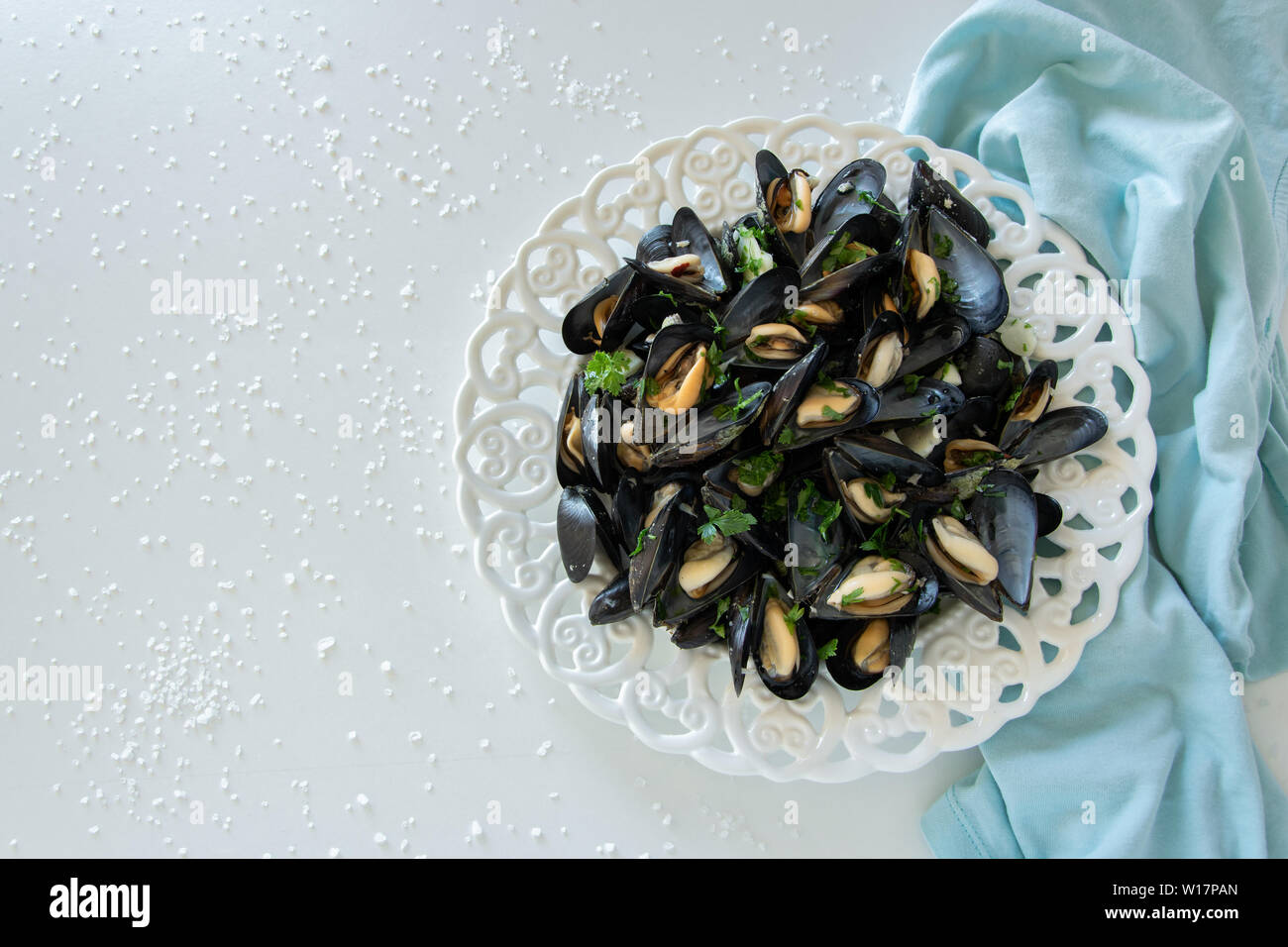 Cooked delicious black mussel, salty white background. Healthy eating concept, rich protein food