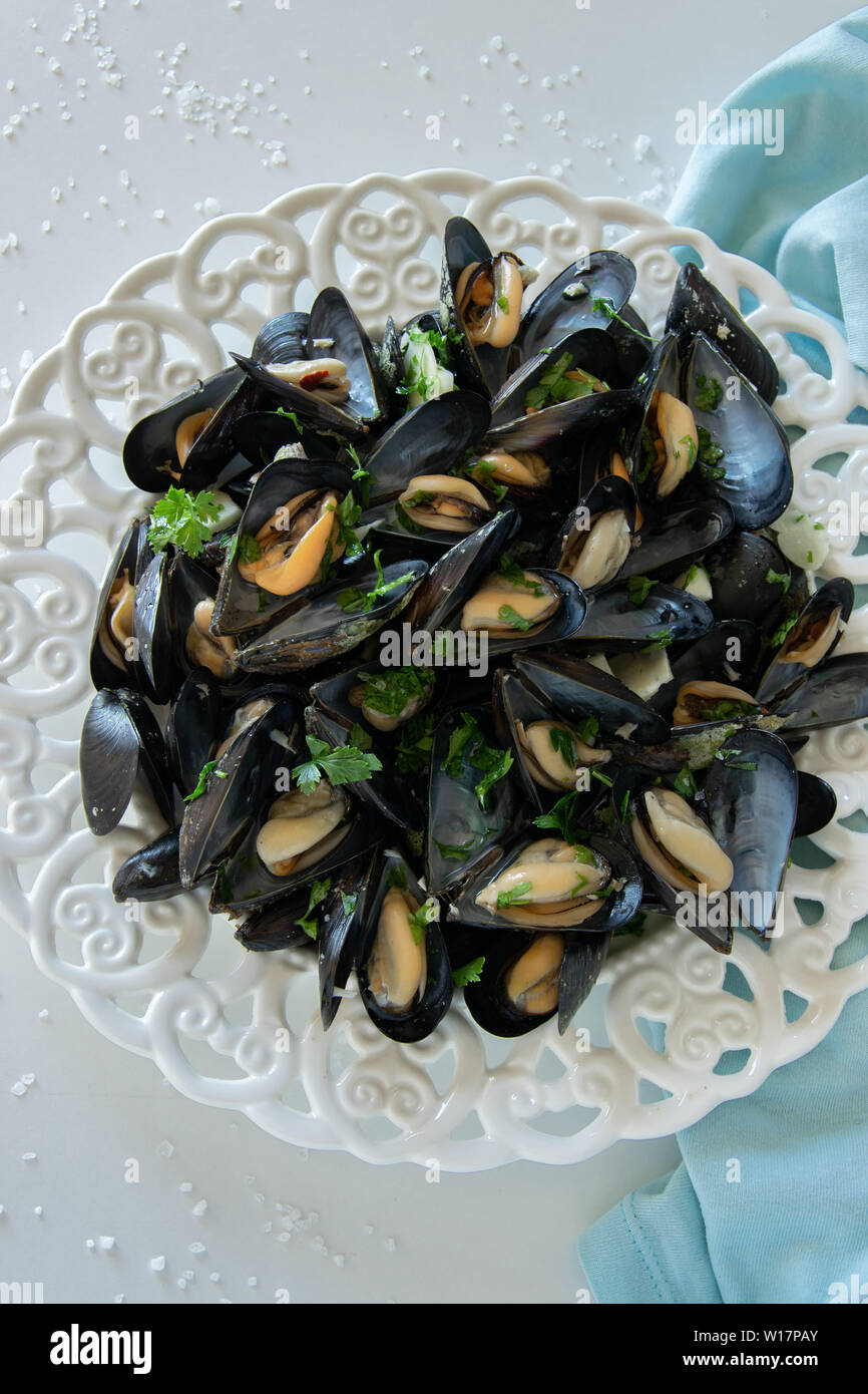 Cooked delicious black mussel, salty white background. Healthy eating concept, rich protein food