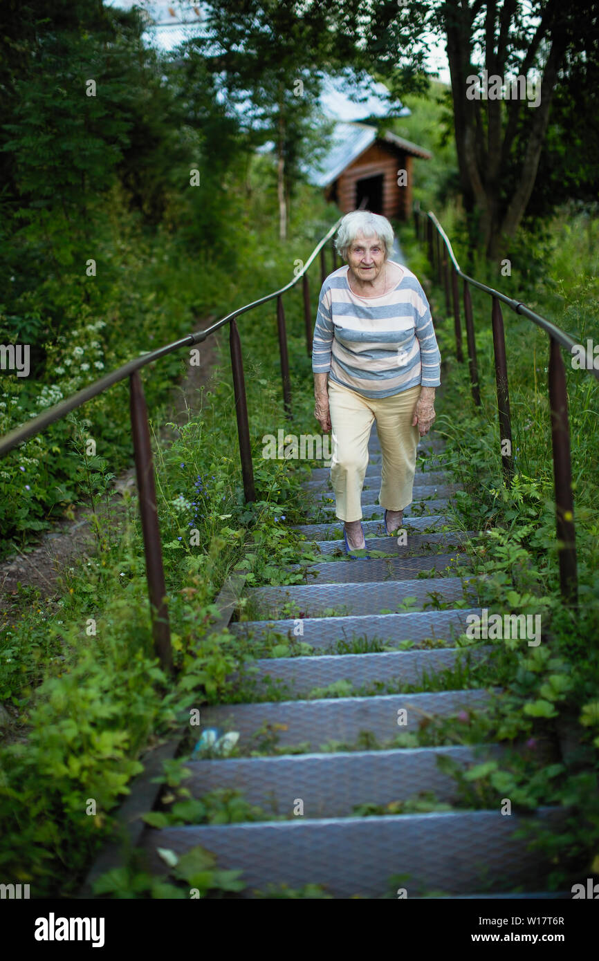 Happy smiling old woman walks hi-res stock photography and images - Alamy