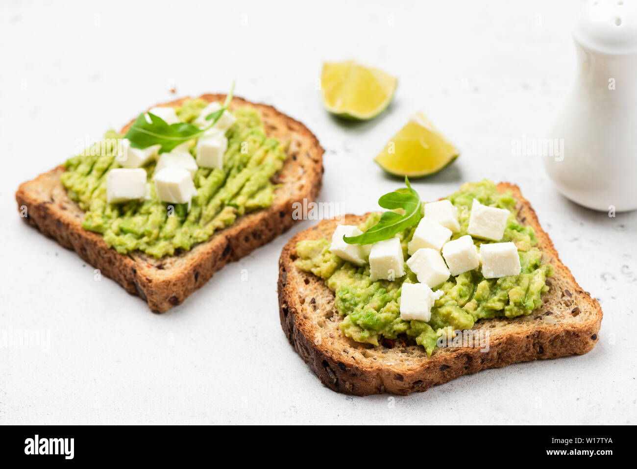 Bread toast with mashed avocado and feta cheese. Healthy breakfast or snack Stock Photo