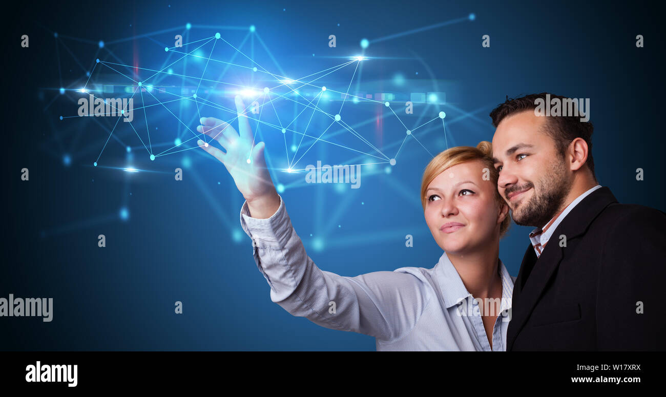 Man and woman touching hologram screen displaying modern web system Stock Photo