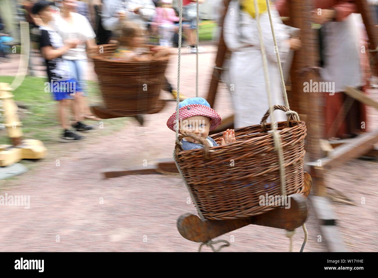 Beijing, Finland. 29th June, 2019. A child enjoys a manually-operated merry-go-round in Turku, southwestern Finland, on June 29, 2019. The annual Medieval Market, one of the largest historical events in Finland, is held in Turku from June 27 to June 30. Modern people can enjoy ancient music and dance, historical street plays, traditional food and handicrafts during the event. Credit: Zhang Xuan/Xinhua/Alamy Live News Stock Photo