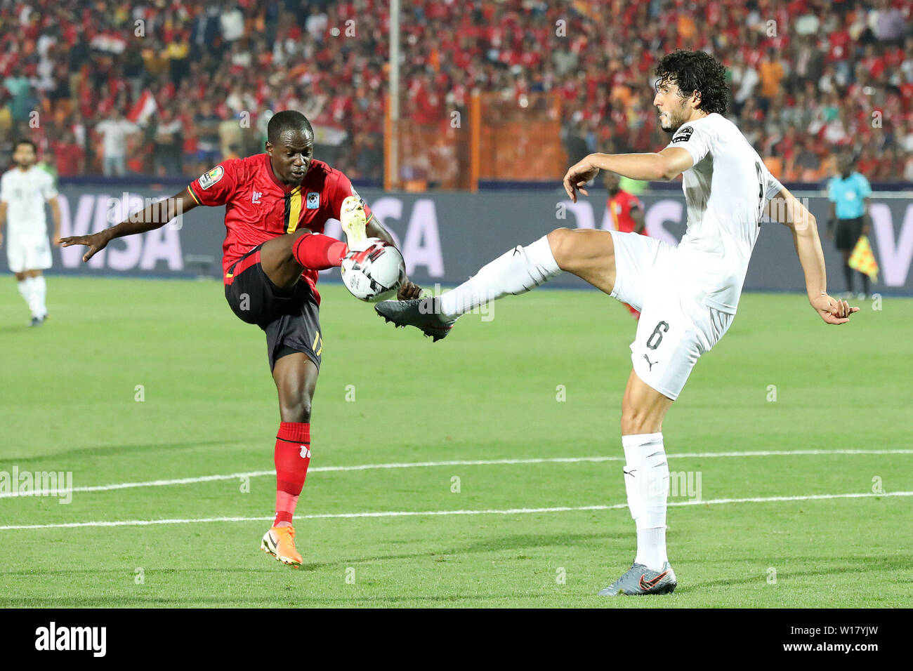 Cairo, Egypt. 30th June, 2019. Farouk Miya (front L) of Uganda vies with Ahmed Elsayed Ali Elsayed Hegazy of Egypt during the 2019 Africa Cup of Nations group A match in Cairo, Egypt, June 30, 2019. Credit: Wang Teng/Xinhua/Alamy Live News Stock Photo