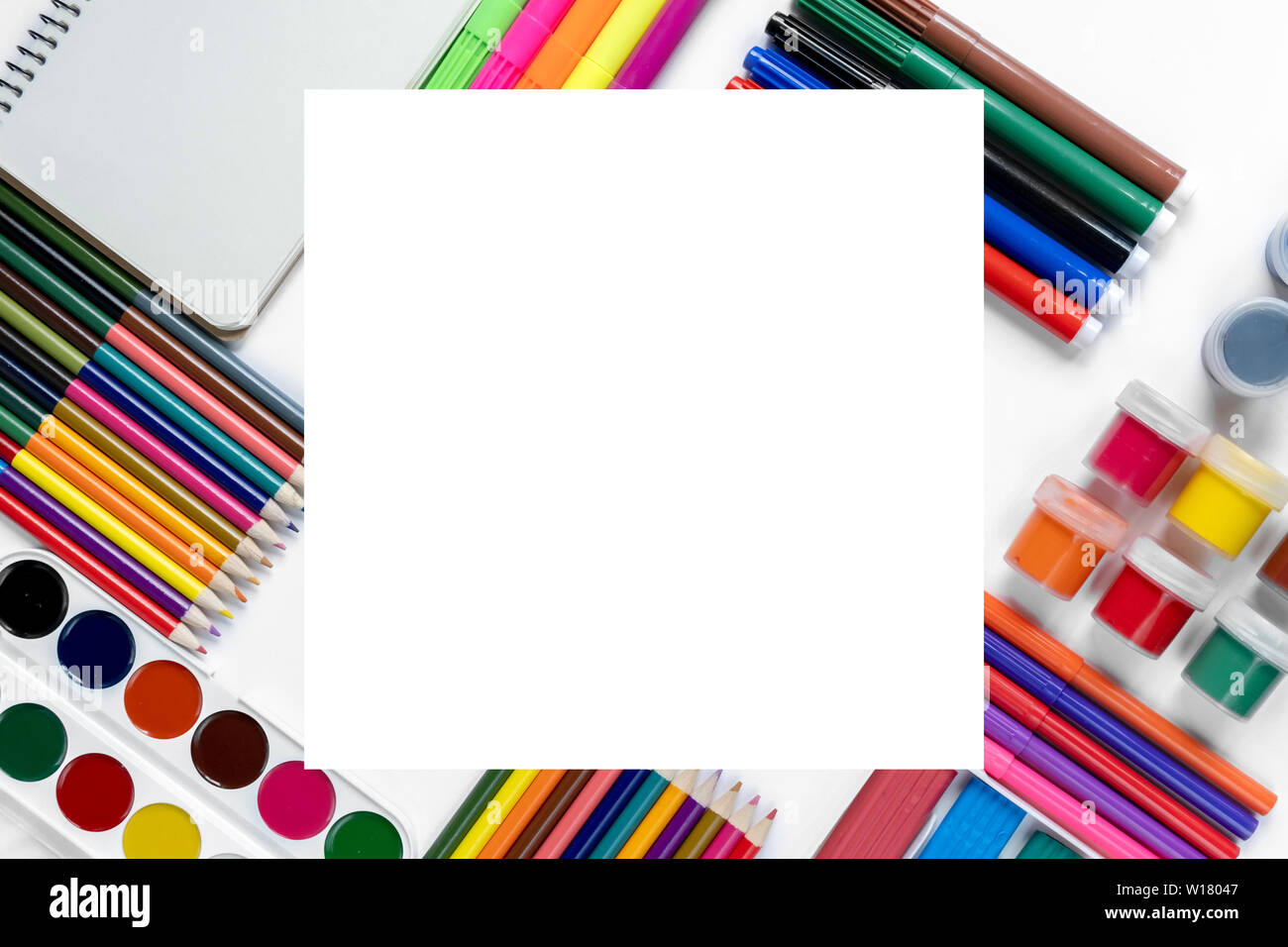 Creative flat lay back to school concept with colored pencils, gouache ...