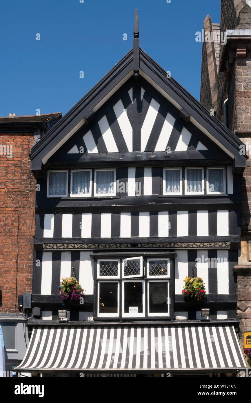 A half timbered building next to Congleton town hall in the High Street, Cheshire, England, UK Stock Photo