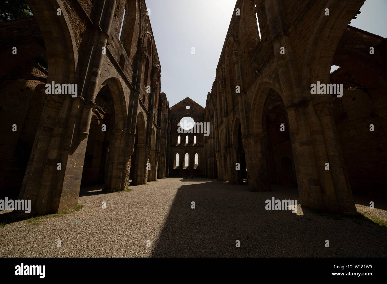 The central nave of the roofless gothic abbey of San Galgano, located in the tuscan countryside, on a sunny day. Chiusdino, Italy. Stock Photo